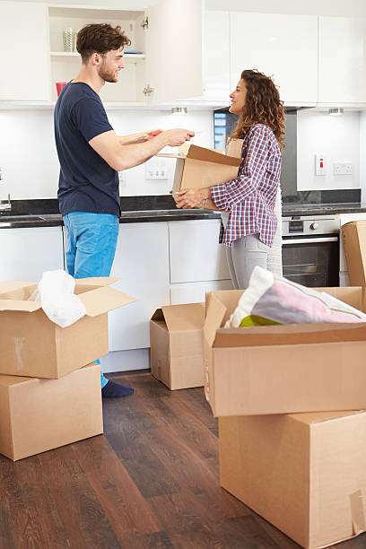 istock Couple Moving Into New Home And Unpacking Boxes 459190657