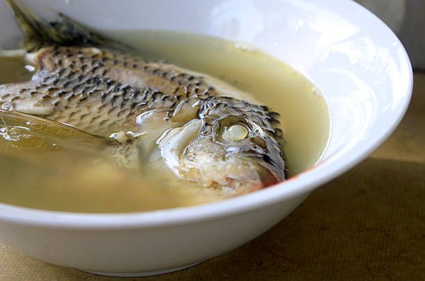 sopa de pescado en un tazón - caldo de pescado fotografías e imágenes de stock