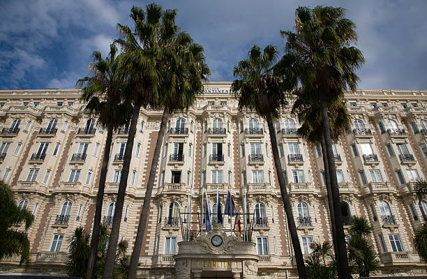 Cannes, Carlton Hotel Intercontinental with palmtrees, France Cannes, Carlton Hotel Intercontinental, one of the most important hotels along Boulevard de la Croisette, Cannes, Cote d'Azur, France. Place to be for movie stars during Cannes Film festival cannes film festival stock pictures, royalty-free photos & images