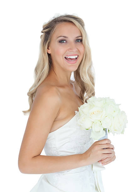 istock Joyful young blonde bride holding a bouquet 459205415