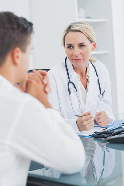 istock Doctor reassuring a worried patient 459208821