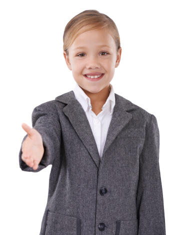 Studio shot of a young girl pretending she is a businesswoman and extending her arm out in greeting
