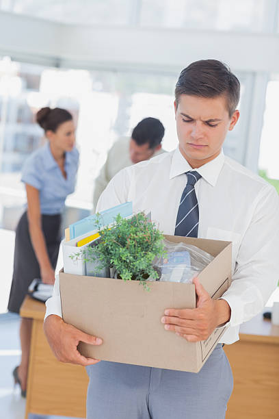 istock Upset businessman leaving office after being laid off 459211483
