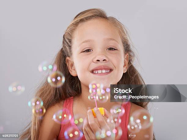 Blowing Bubbles Stock Photo - Download Image Now - Bubble Wand, Girls, Indoors