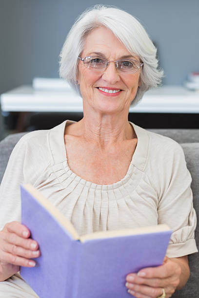 istock Mature woman holding book 459213651