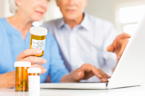 Cropped shot of senior couple researching medication online. Horizontal shot.