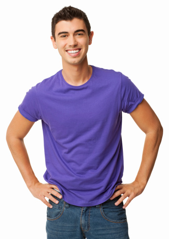 Portrait of happy young man in casual wear standing with hands on hips. Vertical shot. Isolated on white.