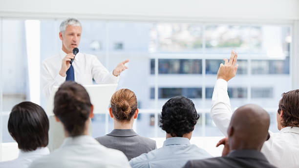 istock Businessman raising his hand while looking at a colleague 459215423