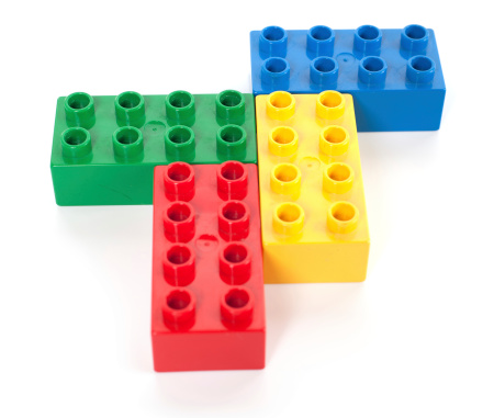Albuquerque, NM - December 4, 2011: Duplo bricks are twice the length, height and width of traditional Lego bricks (eight times the size in volume), as a result being easier to handle &amp;amp;ndash; as well as being far harder to swallow &amp;amp;ndash; by younger children. Despite their size, they are still compatible with traditional Lego bricks. Initially launched in 1969, the Duplo range has gone on to include sets with figures, cars, houses and trains. These Duplo elements are from 1988.