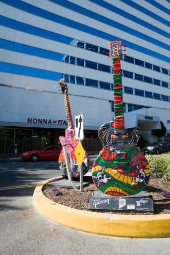 West Hollywood, California, USA - May 17, 2011: Street level view of two of the many uniquely decorated ten foot tall Gibson guitar replicas sitting on display in the center median on Sunset Boulevard in West Hollywood.
