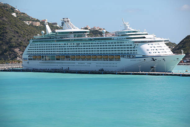 Port Canaveral, United States - October 26, 2013: A Disney cruise ship is docked in Port Canaveral, Florida. The ship is waiting for passengers to board and begin their cruise. Port Canaveral is the home port for the Disney cruise ships. Port Canaveral is one of the busiest ports in the world. Many of the staterooms and the yellow lifeboats hanging on the side of the ship are visible. Disney cruises are popular not just with children and families, but adults as well.
