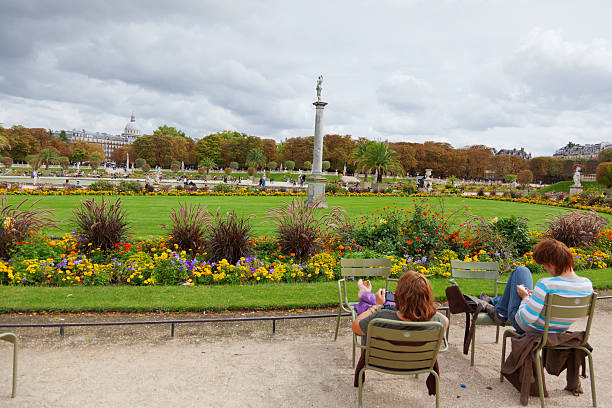 Paris, France - September 06, 2011 : Young people having a break in Luxemburg Gardens (Jardin du Luxembourg) on a cloudy day