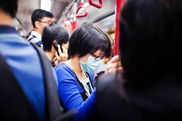 frau mit maske im u-bahnzug - swine flu fotos stock-fotos und bilder