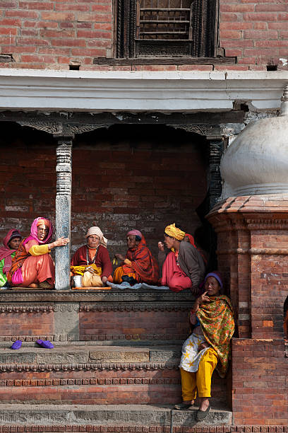 old Nepalese woman Pashupatinath, Kathmandu Nepal - February 06,2011: Old woman are sitting outdoors in Temple. Pashupatinath Temple is the oldest Hindu temple in Kathmandu. india indigenous culture indian culture women stock pictures, royalty-free photos & images