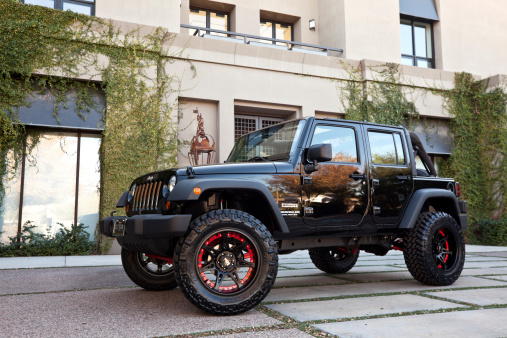 Scottsdale, United States - December 6, 2011: A parked black 2010 Jeep Wrangler, this particular Jeep has a custom lift kit and wheels.