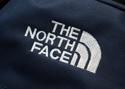 Vancouver, Canada -- December 6, 2011:Close up of The North Face logo stitched on a backpack.  The North Face is a well known American outdoor wilderness clothing and equipment company based in California.