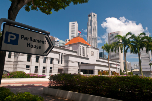 Singapore, Singapore - July 01, 2011: The exterior view of the Parliament House of Singapore, with skyscrapers of central business district in background.
