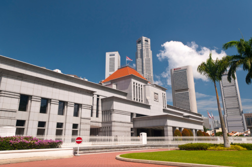 Singapore, Singapore - July 01, 2011: The exterior view of the Parliament House of Singapore, with skyscrapers of central business district in background.