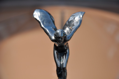 Bournemouth, UK - May 2, 2009: A close up of the iconic 'Silver Lady' hood ornament on a classic Rolls Royce beige coloured car.