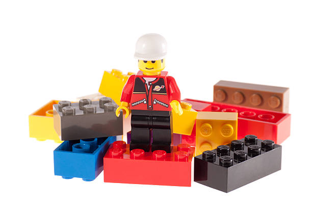 lego-mann auf ziegel - lego construction toy isolated on white isoalted stock-fotos und bilder