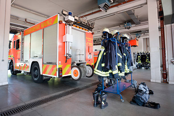 Mainz, Germany - September 3, 2011: Vehicle hall of fire brigade Mainz, Germany with emergency vehicles and fire trucks ready for operation. In the foreground firefighters protective clothing ready to jump in. Feuerwache 1, Mainz