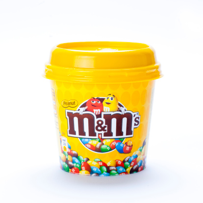 Merano, Italy - August 24, 2011: : A M&M\\'s container with peanuts M&M\\'s isolated on white.M&M\\'s are named after their creators Mars & Murry and are a brand of the Mars Corporation.