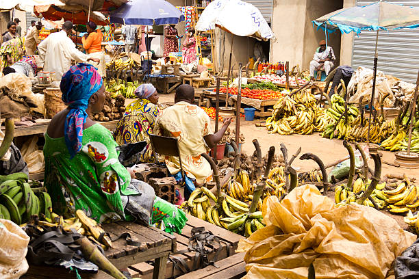 Yaounde Market day Yaounde, Cameroon -  March 08, 2011: People on a crowded market on the street. There are a lot of bananas on this side of the market. yaounde photos stock pictures, royalty-free photos & images