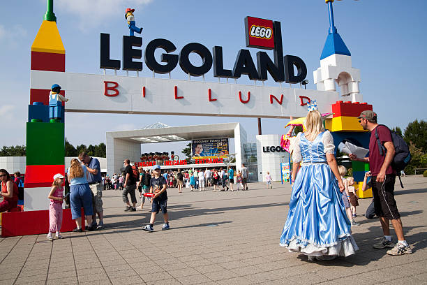 Legoland Entrance Billund, Denmark - August, 02th 2011: The Legoland sign and logo over the entrance in Billund, Denmark. A tourist is getting directions from an employee. billund stock pictures, royalty-free photos & images