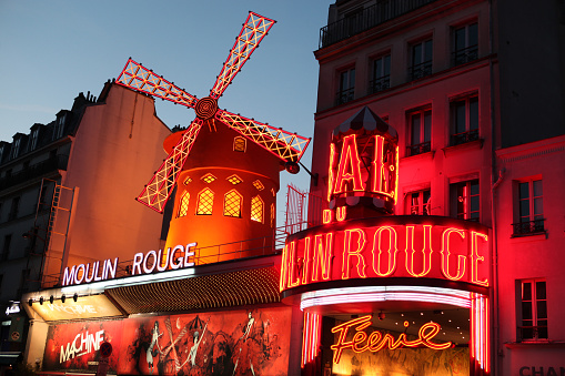 Paris, France - July 31, 2011: Le Moulin Rouge(Red Mill) is a cabaret built in 1889. It\'s situated near Montmartre in the district of Pigalle in the 18th arrondissement of Paris. On this picture le moulin rouge is at the dusk. 