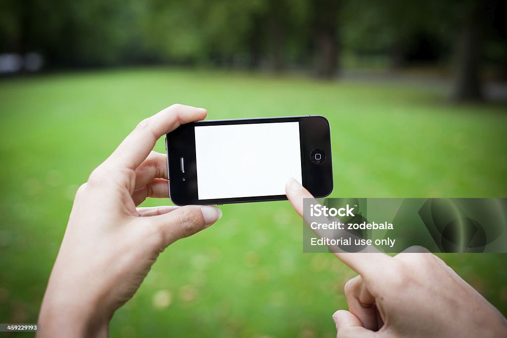 iPhone 4 con pantalla blanca, al aire libre - Foto de stock de 30-39 años libre de derechos