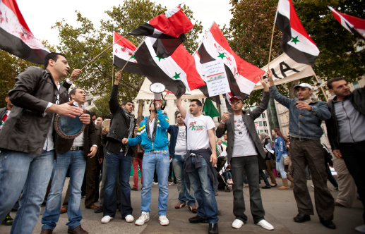 London, UK - October 8, 2011: A group of Syrian nationals gathered together in London\\'s Trafalgar Square, as part of a Stop the War demo, making use of the opportunity to draw attention to the civil unrest currently facing their home country.