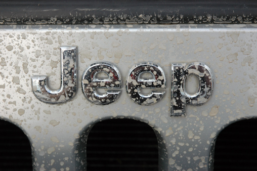 Australia - September 30, 2010: Jeep name badge or logo on a silver wrangler with water splash marks. Jeep will expand its range with three two-wheel-drive models in Australia in the first half of 2012 as the brand looks to broaden the appeal of its SUVs beyond its traditional 4WD customer base.