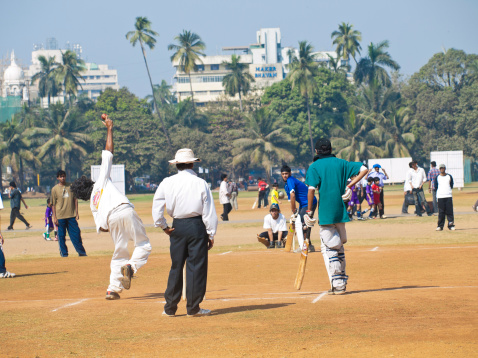 Mumbai, India - January 23, 2008: Recreational Cricket being played on a public park in Central Mumbai. Cricket is a popular past time in India, and can be seen played on the streets and in parks throughout the country.