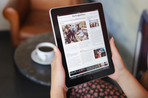 Astanbul, Turkey - September 5, 2011: Womans hands holding an Apple iPad displaying The New York Times. The New York Times is an American daily newspaper founded and continuously published in New York City since 1851. The iPad is produced by Apple Computer, Inc.