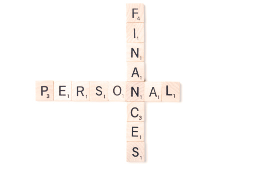 Brooklyn, USA - January 23, 2012: Wooden blocks of the English language version of Scrabble crossword game manufactured by Hasbro spelling out the words: Personal Finances.  Blocks are isolated on white background. Image created in a studio environment. Scrabble is a very popular board game in the USA.  It can be found in around 30% of American households.