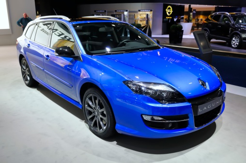 Brussels, Belgium - January 10, 2012: Blue Renault Laguna Break on display during the 2012 Brussels motor show. People in the background are looking at the cars.