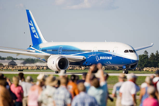 Boeing 787 Dreamliner Wittman Regional Airport, Oshkosh, Wisconsin, USA - July 29, 2011: Crowd watching a Boeing 787 taxing to runway for takeoff at the Air-Venture airshow. wow airlines stock pictures, royalty-free photos & images