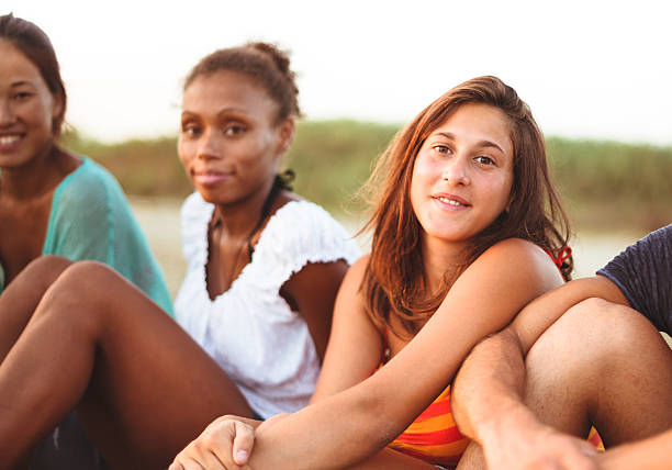 istock caucasian man smiling on the beach with friends 459232893