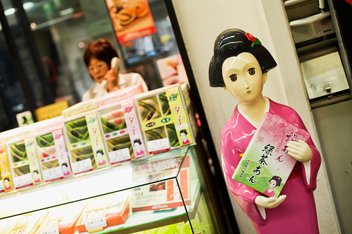 Tokyo, Japan - May 21, 2010: Restaurant in Tokyo with a welcoming mannequin holding a menu with traditional appearance.