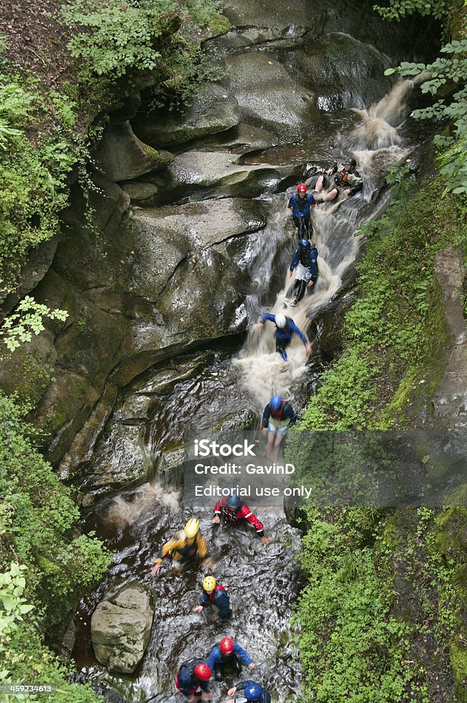 How Stean Gorge in North Yorkshire Lofthouse, United Kingdom, August 19th 2011: Men and women dressed is protective safety gear and helmets descend through the famous How Stean Gorge in North Yorkshire. This gorge is west of Lofthouse in Upper Nidderdale. The gorge is some 80\' deep and is popular with cavers, potholers and daytrippers. The stream cascades over multiple small waterfalls. 2011 Stock Photo