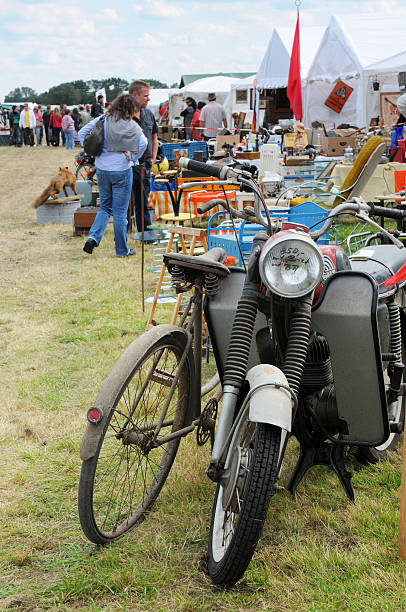 bicicleta e motocicleta no mercado de pulgas com visitantes ao fundo - puzzelspiel - fotografias e filmes do acervo