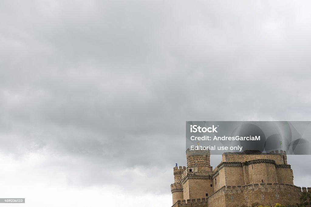 Manzanares El Real Castle in Madrid Madrid, Spain - June 9, 2013: Panorama view of the New Castle of Manzanares el Real against a cloudy sky. Also known as Castle of los Mendoza, it's a palace-fortress erected in the 15th century in Romanesque-MudAjar style in the town of Manzanares el Real in Madrid, Spain. It currently operates as a museum, and it appears in the movie "El Cid" featuring Charlton Heston and Sophia Loren. Aging Process Stock Photo