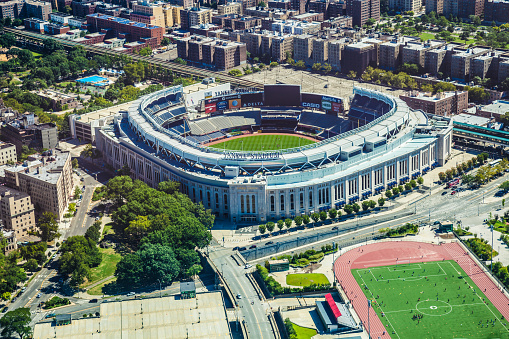 New York City, New York, USA - August 24, 2013:  Aerial view seen from helicopter of Yankee Stadium and near a soccer field with a lot of people playing inside.
