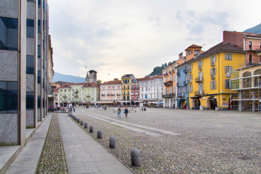 Locarno, Switzerland - September 27, 2013: Piazza Grande is the main square of Locarno. In the picture we see the old houses, vans and people walking around the square. Every year on the Piazza Grande take place Locarno Film Fesitival.