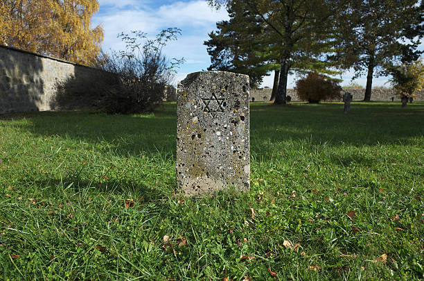 Mauthausen, Austria - Oct 22, 2013: The Star of David engraved in a gravestone in the cementery of the former \