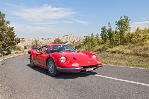 Brisighella, RA, Italy - August 31, 2013: driver and passenger on a vintage Ferrari Dino GT at rally 