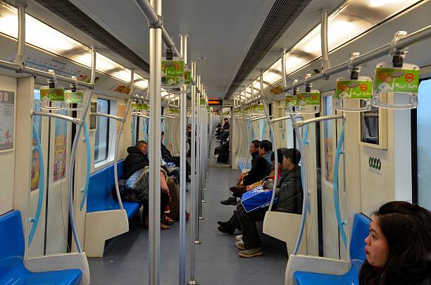 Central Station, Hong Kong- 18 Feb 2024: MTR train chair with 6 seats, handle and red pole with window in the MTR train railway. The train is in the station.