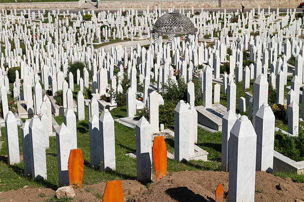 Martyr's Memorial Cemetery Kovaci In Sarajevo Sarajevo, Bosnia and Hercegovina - July 22, 2013: Cemetery For Muslims Killed During The Conflict In The Early 1990's In Sarajevo, Bosnia and Hercegovina. Some of the martyrs are  recently met their friends. ethnic cleansing stock pictures, royalty-free photos & images