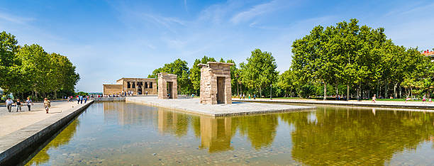 Madrid, Spain - September 15th, 2013: Tourist are walking in Parque del Oeste where Temple of Debod is located. Temple's reflection visible in the surrounding pool. This photograph was taken midday.