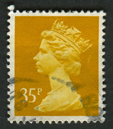 Gomel, Belarus - April 30, 2013: Postage stamp. A stamp printed in UK shows image of Elizabeth II is the constitutional monarch of 16 sovereign states known as the Commonwealth realms, in yellow, circa 1991.